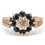 9ct gold diamond and blue spinel flower head ring with engraved shoulders, size N, 3.3g