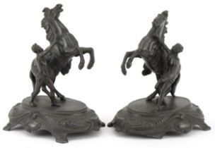 Pair of classical patinated spelter Marley horses with trainers, each 23.5cm high