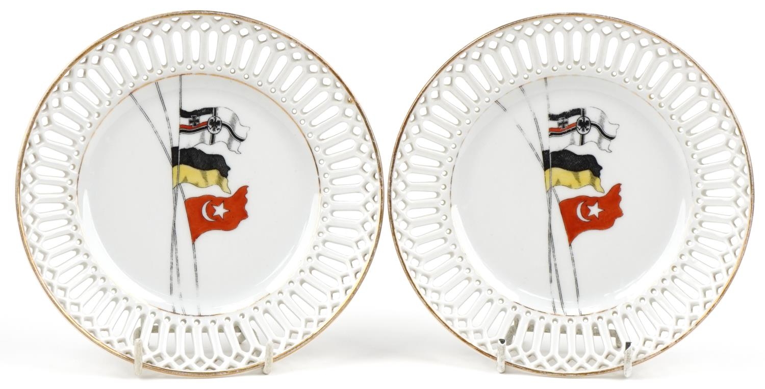 Military interest pair of German porcelain plates having pierced borders, each decorated with