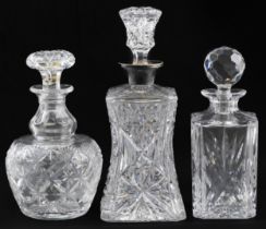 Three cut glass decanters including an example with waisted body having silver collar, London