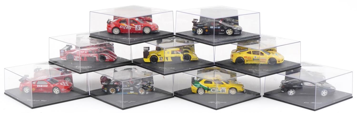Nine Pro Slot 1:32 scale model slot cars with cases including Toyota GT-One, Porsche 911 GT2 and