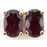 Pair of 9ct gold garnet stud earrings, each 6mm high, total 0.8g