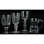 Four glasses including Elizabeth II Queen's Silver Jubilee goblet with air twist stem, the largest