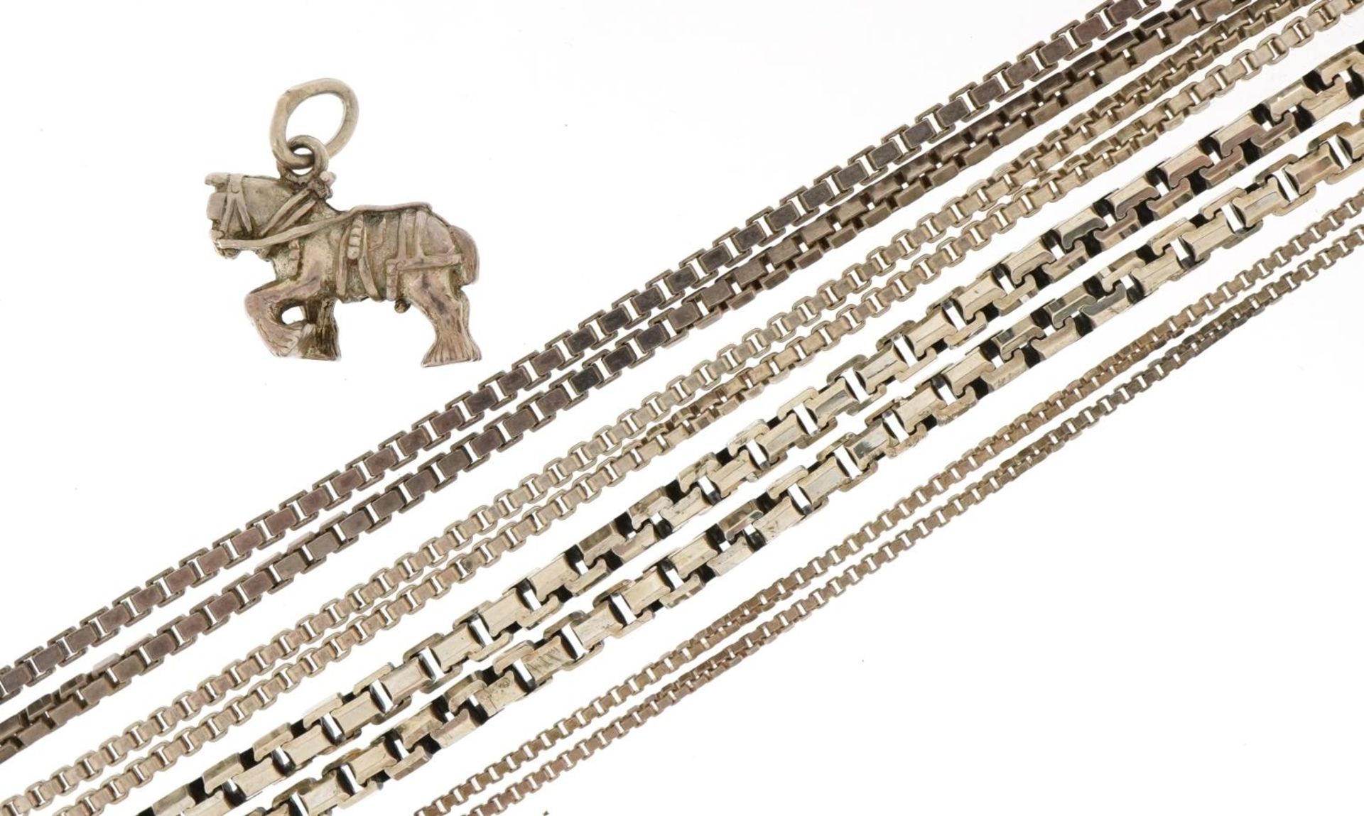 Four silver necklaces and a silver workhorse pendant, the largest 44cm in length, total 41.8g