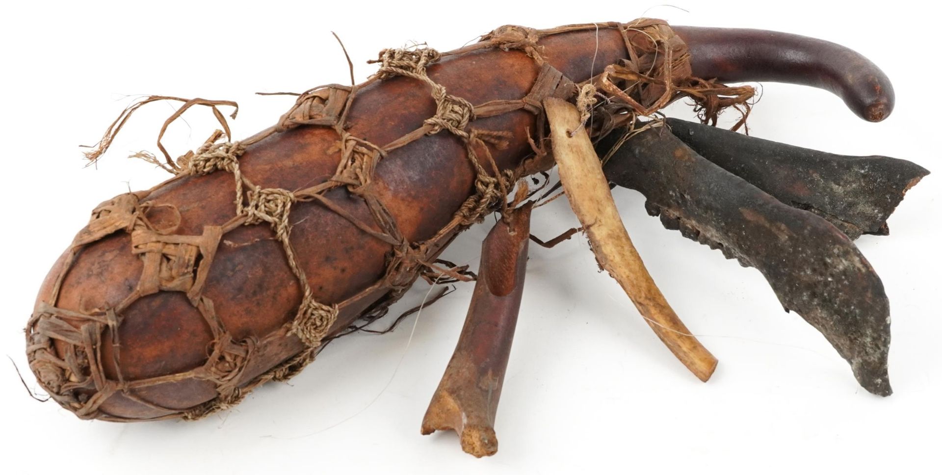 Tribal interest gourd water carrier with attached bones, 45cm in length