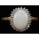 9ct gold cabochon opal and diamond cluster ring, the opal approximately 9.80mm x 7.80mm x 2.80mm