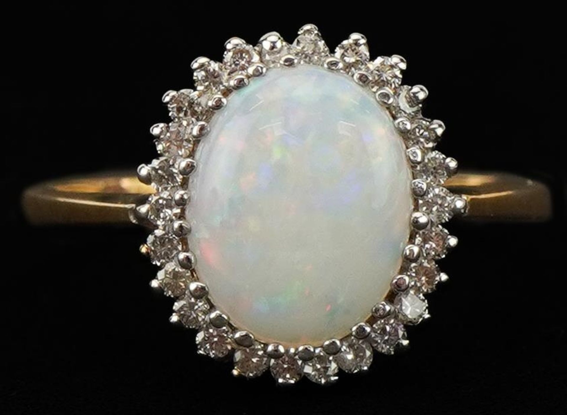 9ct gold cabochon opal and diamond cluster ring, the opal approximately 9.80mm x 7.80mm x 2.80mm