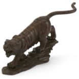 Japanese patinated bronze tiger on a rock, 13cm in length