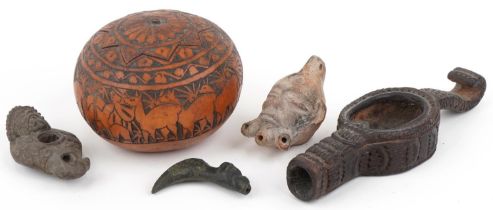 Tribal artefacts including a zoomorphic bronze spout in the form of a dog's head, Peruvian folk