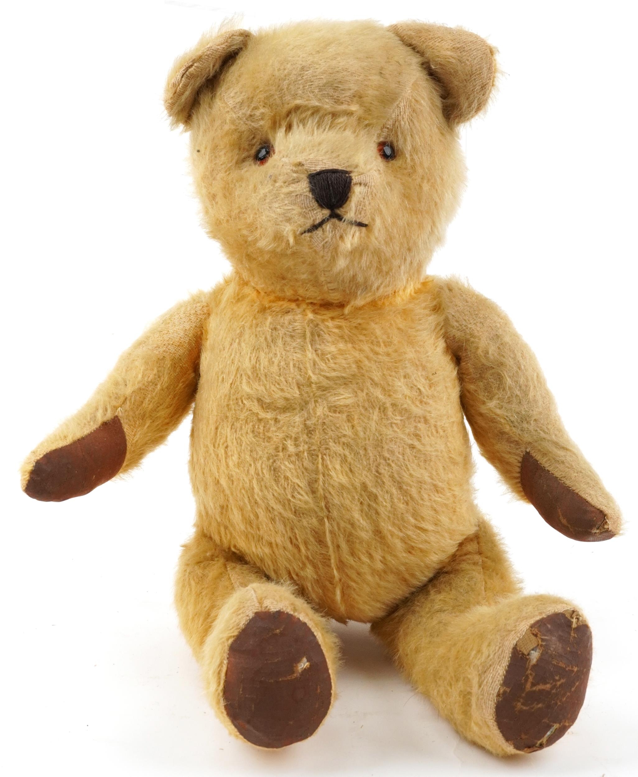 Early 20th century golden straw filled teddy bear with growler and jointed limbs, 44cm high