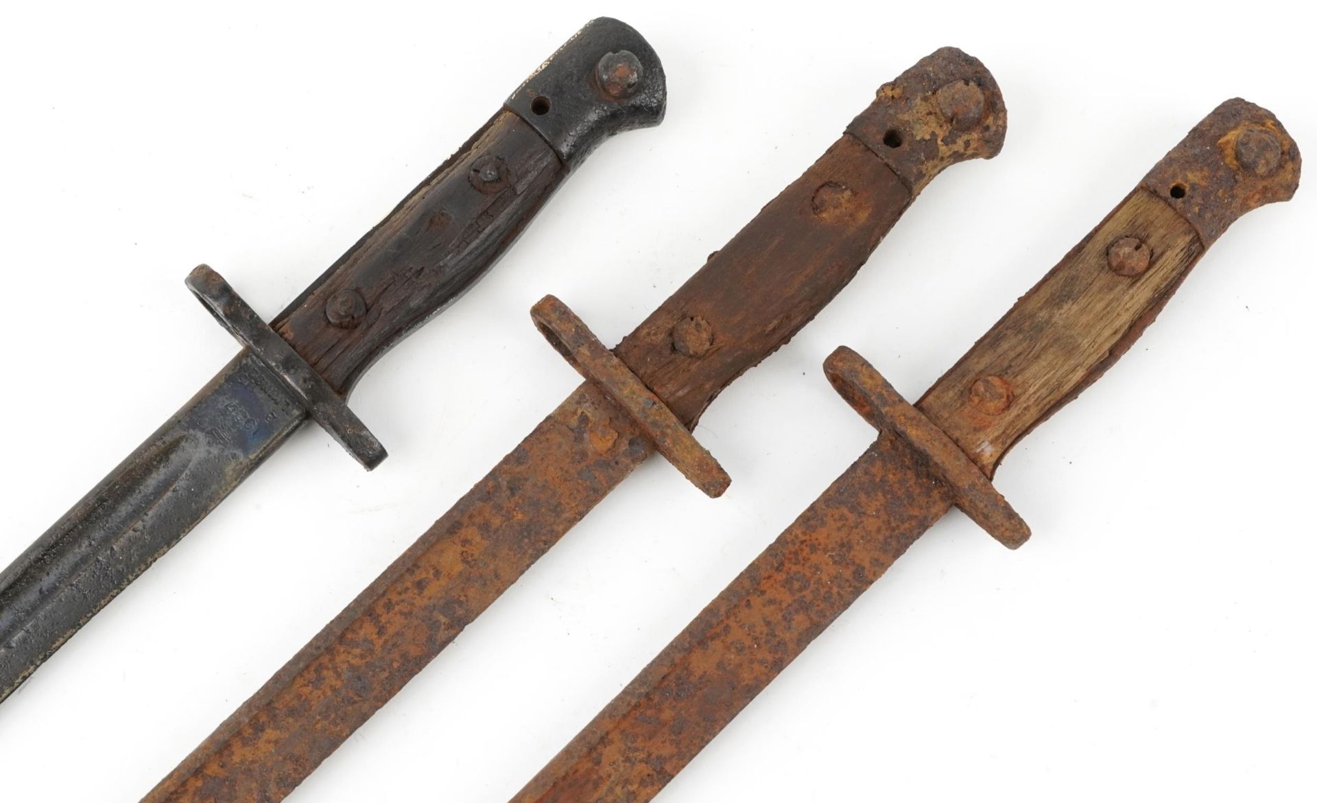 Three military interest World War I bayonets, the largest 57cm in length
