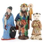 Three Chinese and Japanese figures including a Satsuma example of a young boy, the largest 23.5cm