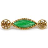 Chinese 18ct gold green jade bar brooch on a yellow metal safety chain, 3.5cm wide, total 3.4g