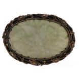 Chinese white metal filigree brooch inset with a green jade panel carved with foliage, 5cm wide,