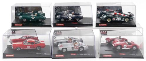 Six Carrera Evolution slot cars with cases comprising Porsche 911 GTI 98, Jaguar D Type, Jaguar D