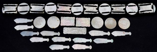 Chinese Canton mother of pearl gaming counters, some arranged on a belt including examples of