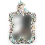 19th century German floral encrusted wall mirror surmounted with a maiden head and two Putti, 57cm x
