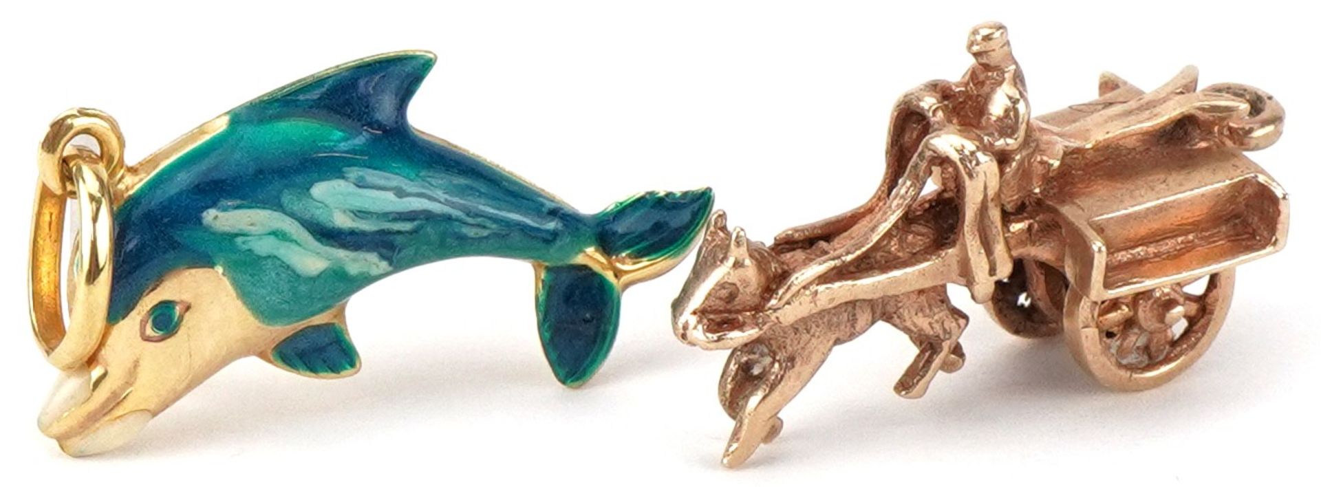 Two 9ct gold charms, one enamel, comprising one in the form of a dolphin and a horse drawn cart, the