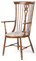 Arts & Crafts beech and elm stick back open armchair with tapestry upholstered seat, raised on