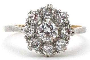 18ct gold and platinum diamond cluster ring, the central diamond approximately 0.32 carat, each