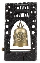 Chinese bronze dragon bell mounted on a carved hardwood stand with metal inlay, 44cm high