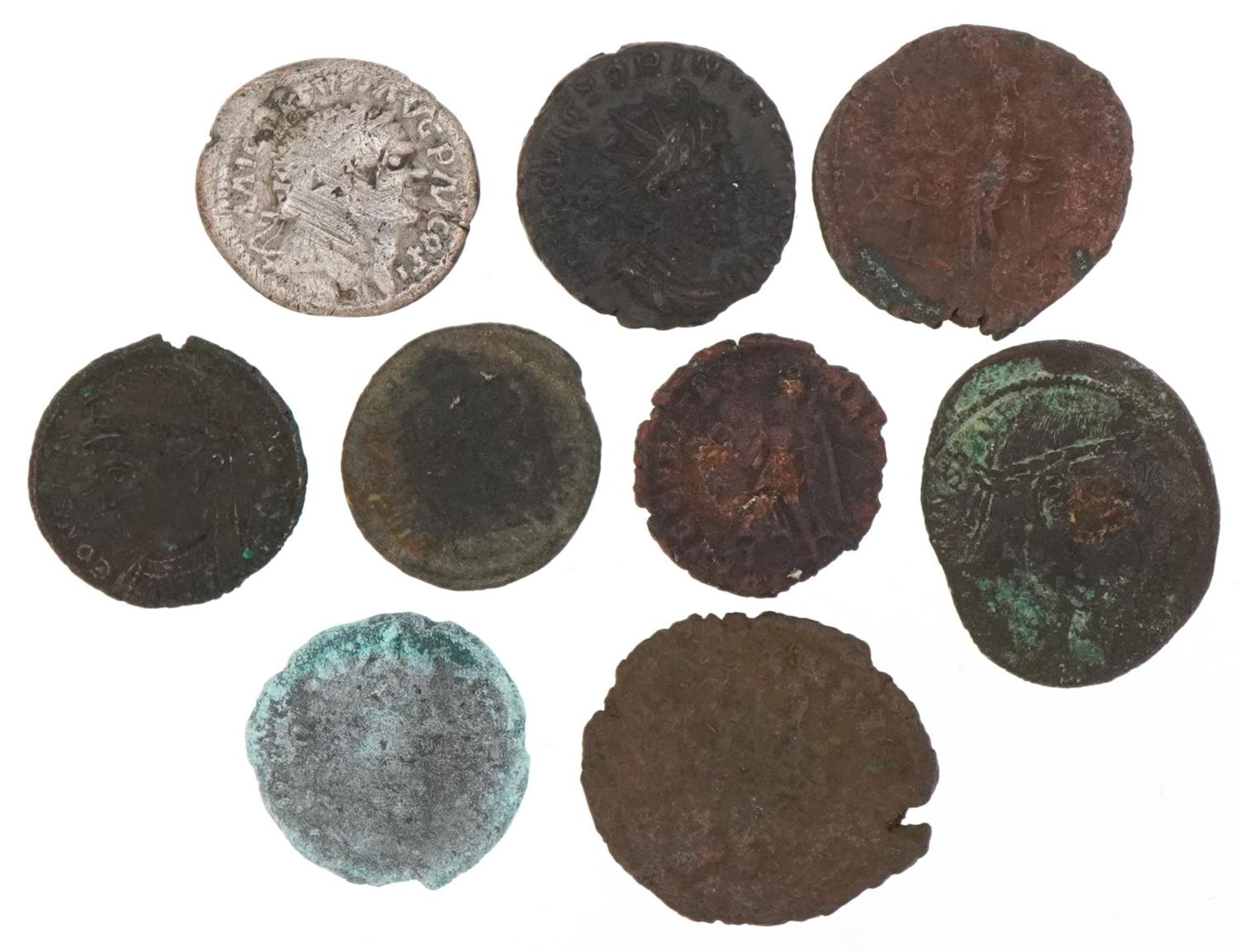 Various ancient coins including a Roman coin and a silver example