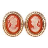 Pair of yellow metal cameo style stud earrings decorated with maiden heads, each 11.5mm high,