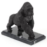 Patinated bronze study of a gorilla raised on a black marble base, 20cm in length