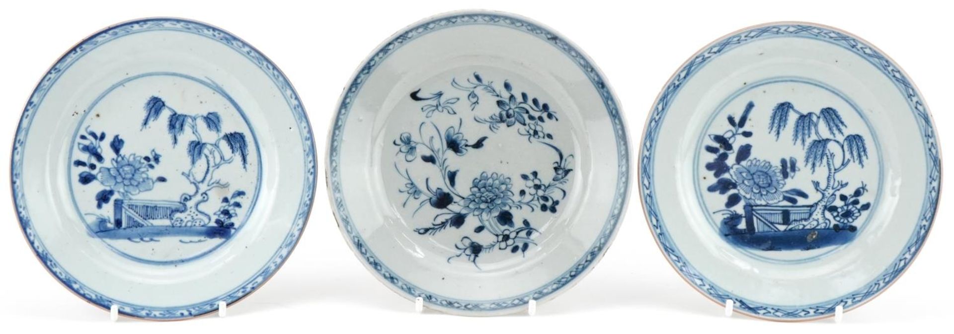 Three 18th century hand painted blue and white plates, two in the Willow pattern, one with