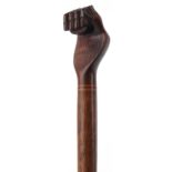Hardwood Pitcairn Islands clenched fist walking stick, 94cm in length