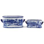 Two blue and white transfer printed porcelain foot baths with twin handles, the largest 48cm wide