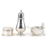 George V and later silver comprising baluster shaped caster, three footed sauce boat and unmarked