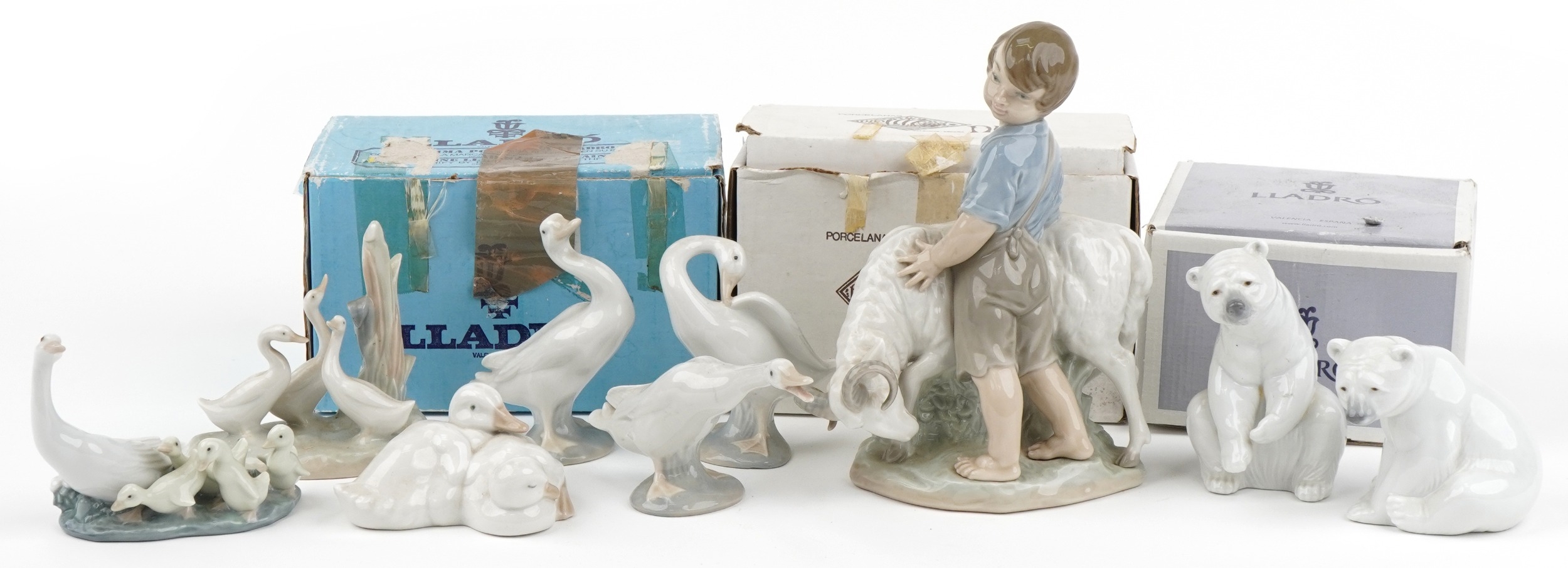 Nine Lladro and Nao figures, animals and groups including two polar bears and a boy with ram, the