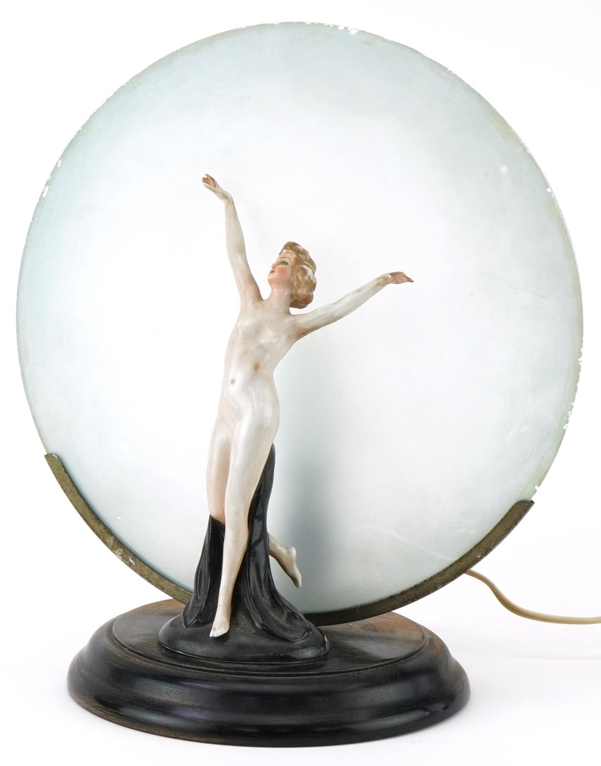 Art Deco porcelain table lamp of a nude female mounted on a wooden base with frosted glass shade,