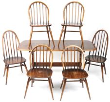 Ercol elm dining table and six stick back chairs, the table 72cm H x 152cm W x 76cm D