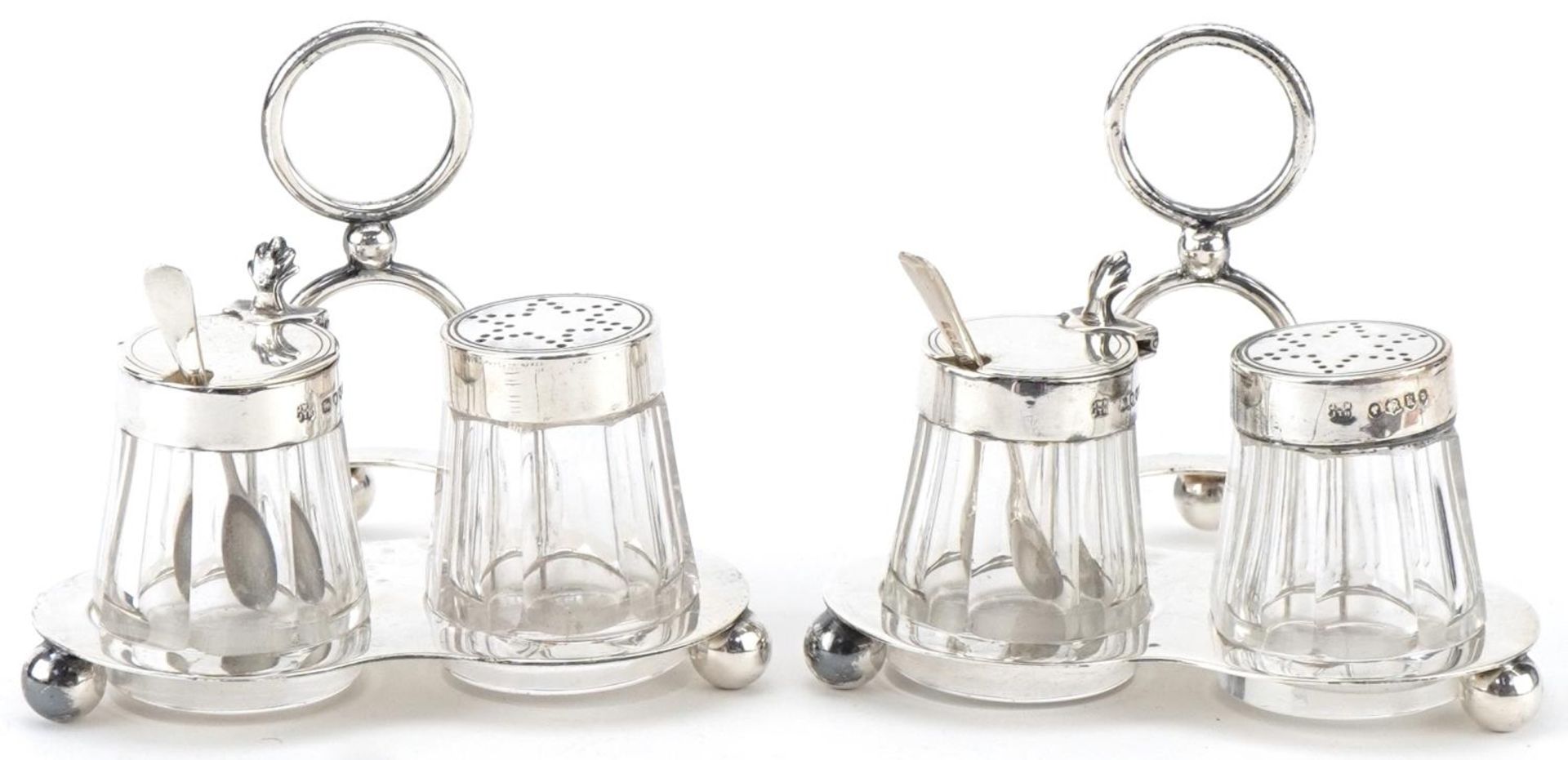 Hukin & Heath, two Victorian silver cruet sets on stand with glass jars, London 1885, each 8cm high,