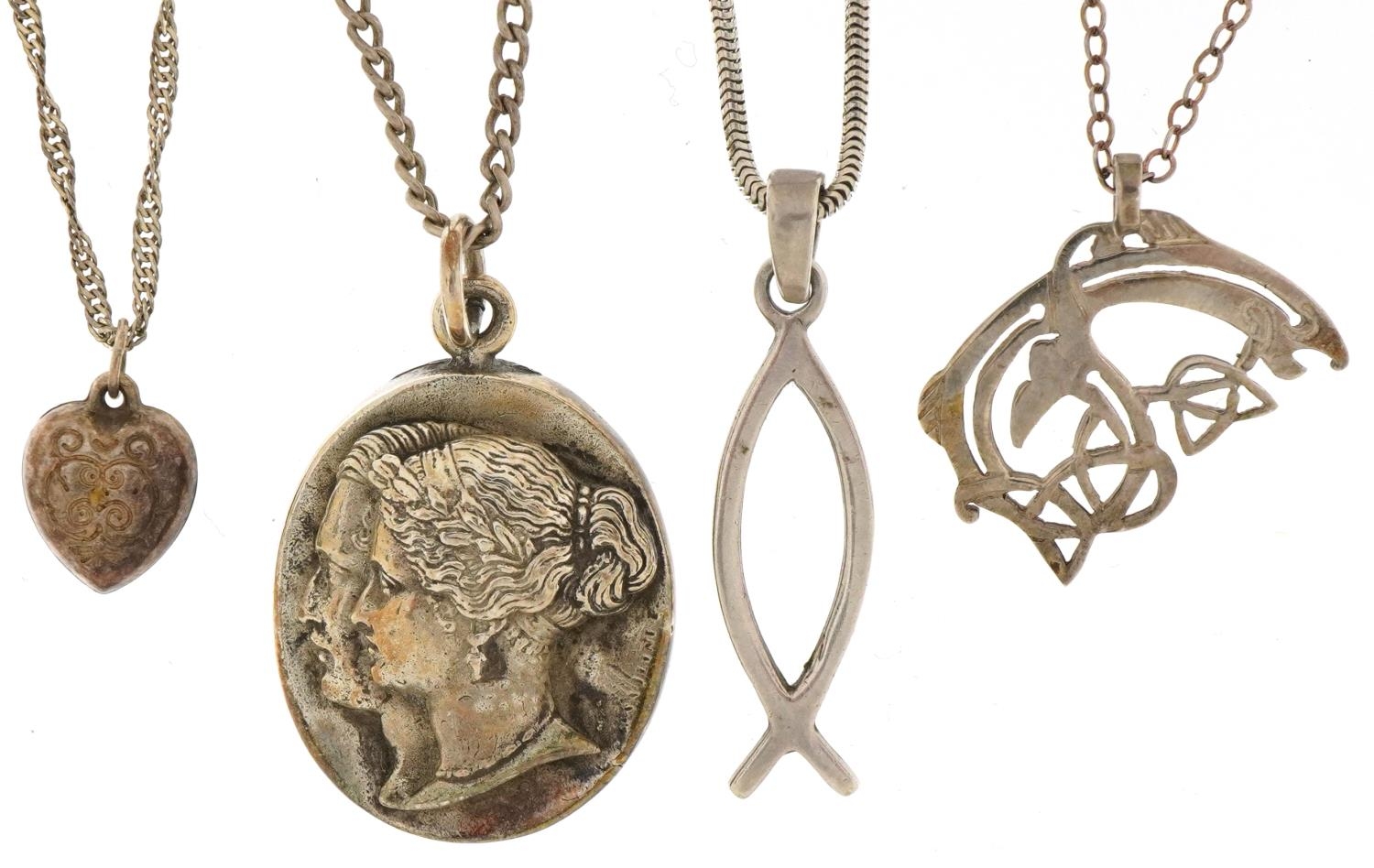 Four silver pendants on silver necklaces including engraved love heart and one Art Nouveau style,