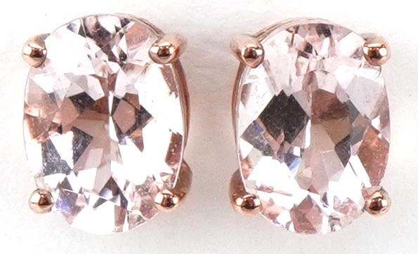 Pair of 9ct rose gold pink stone stud earrings, each 7mm high, total 1.1g