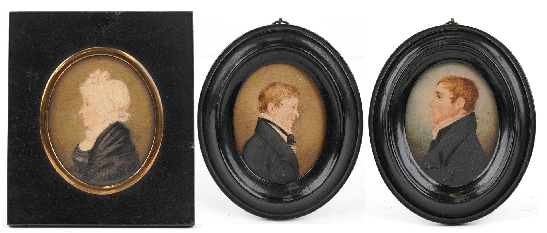 Three Georgian oval hand painted portrait miniatures housed in ebonised frames, including one of