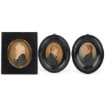 Three Georgian oval hand painted portrait miniatures housed in ebonised frames, including one of