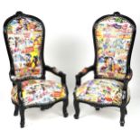 Pair of ebonised child's elbow chairs with comic upholstery, 100cm high