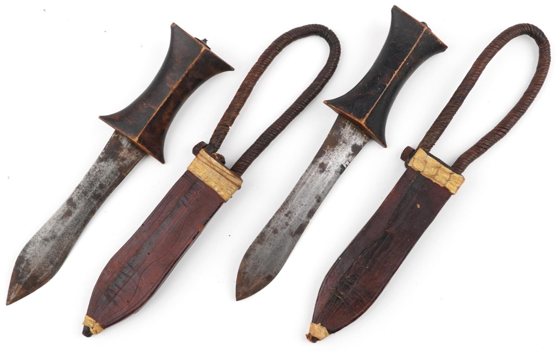 Pair of African Tribal daggers with wooden handles housed in leather sheaths having rope twist