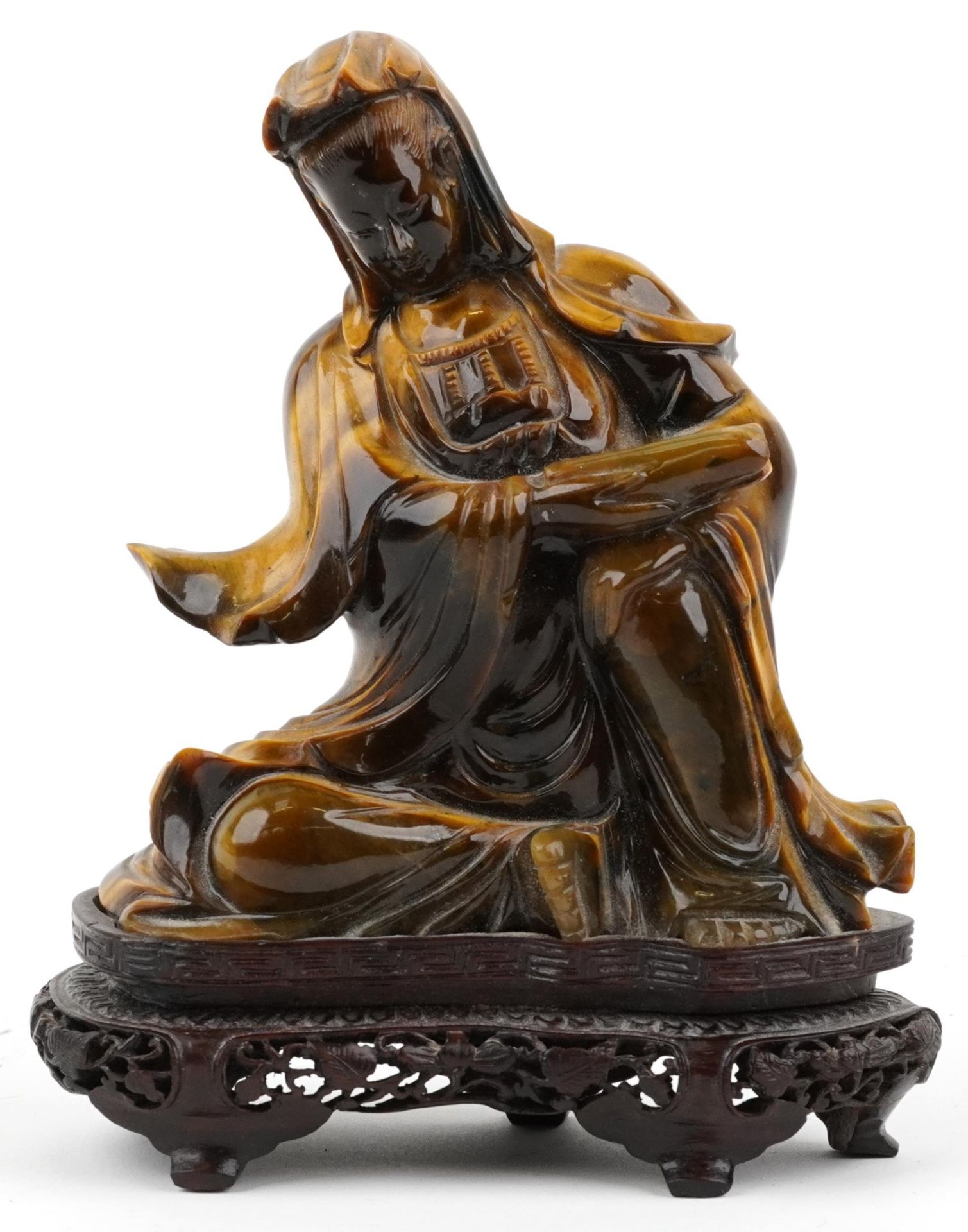 Chinese tiger's eye carving of Guanyin raised on hardwood stand carved with foliage, 16cm high
