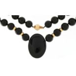 Contemporary black bead necklace with 9ct gold ball clasp and spacers, 52cm in length, 127.0g
