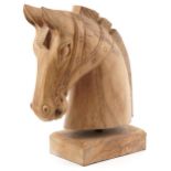 Large lightwood carving of a horsehead on a rectangular block base, 54cm high