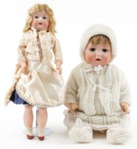 Bisque headed baby doll stamped BP together with a jointed bisque headed doll the largest 36cm high