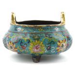 Chinese patinated bronze tripod censer with twin handles enamelled with flowers amongst scrolling