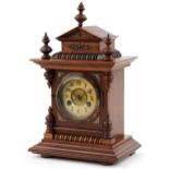 Junghans architectural walnut mantle clock striking on a gong having circular chapter ring with