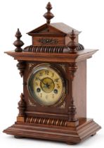 Junghans architectural walnut mantle clock striking on a gong having circular chapter ring with