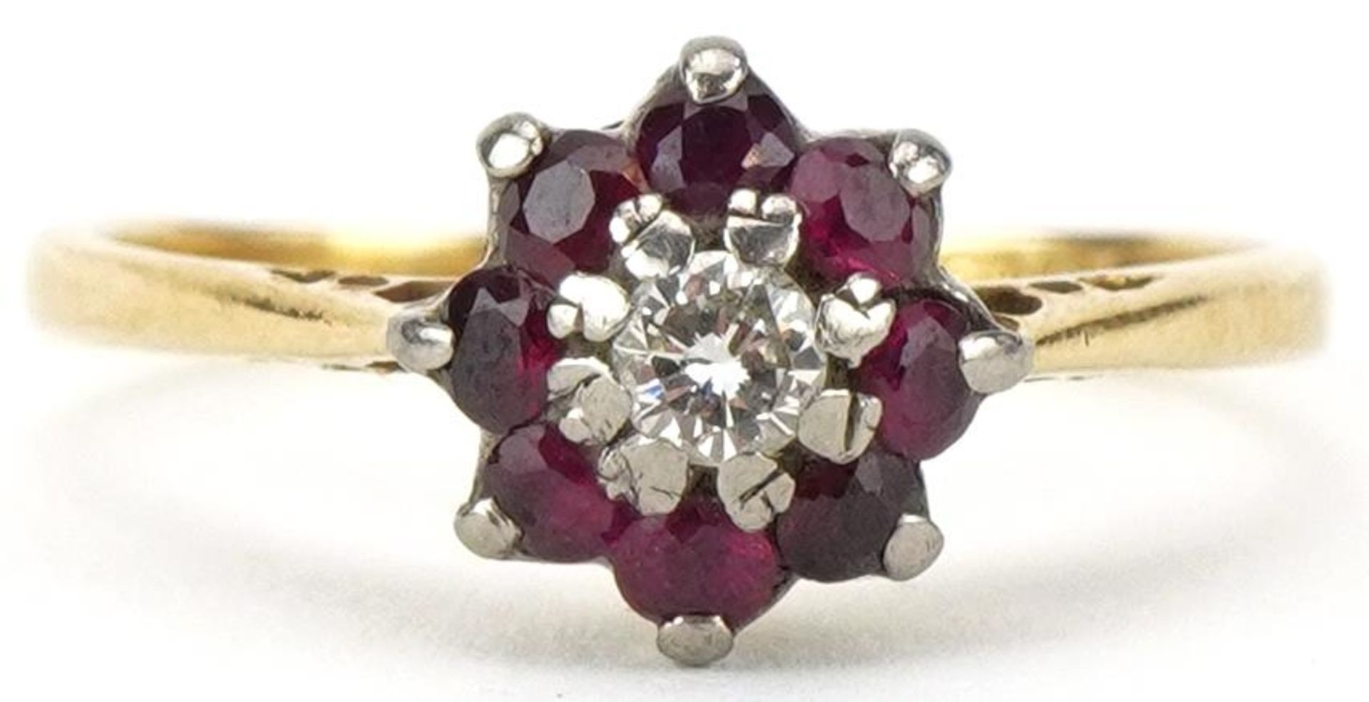 18ct gold diamond and ruby flower head ring, the diamond approximately 0.10 carat, size N, 2.6g